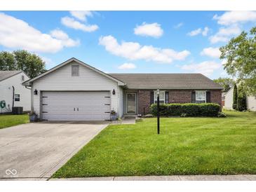 Charming single-story home featuring a brick facade, attached garage, and well-maintained lawn at 905 Congressional Way, Shelbyville, IN 46176