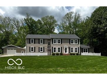 Charming two-story home with large front yard and mature trees at 9650 Copley Dr, Carmel, IN 46290