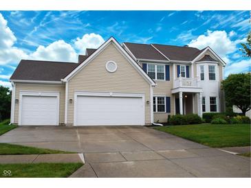 Two-story home featuring a three-car garage, blue shutters, and a small balcony with white columns at 1029 Bridgeport Dr, Westfield, IN 46074