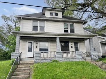 Classic two-story home showcasing its inviting front porch and well-maintained lawn at 1247 Wright St, Indianapolis, IN 46203