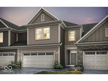 Charming home exterior boasts stone and siding accents, showcasing a welcoming facade and attached garages at 14866 E Keenan Cir # Lot 38, Westfield, IN 46074