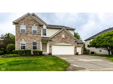 Charming two-story home with a brick and siding exterior, well-manicured lawn, and three-car garage at 16126 Etna Green, Westfield, IN 46074