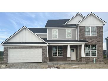 Charming two-story home featuring brick, white trim, gray siding, and an attached two car garage at 18967 Seaforth Way, Westfield, IN 46074