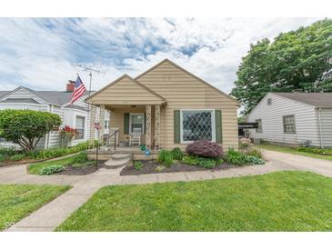 Charming single-story home with a well-manicured lawn and inviting front porch, perfect for relaxing at 1913 Pennsylvania St, Columbus, IN 47201