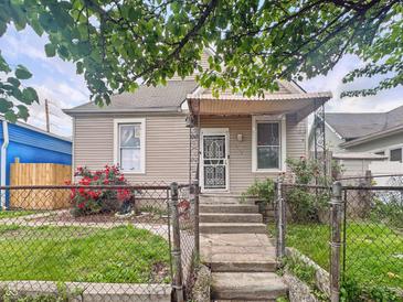 Charming home featuring a cozy front porch, tidy front yard, and an inviting entrance at 2006 N Olney St, Indianapolis, IN 46218