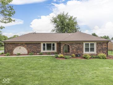 Charming brick home featuring a well-manicured lawn and inviting landscape elements at 2010 Alexandria Dr, Greenfield, IN 46140