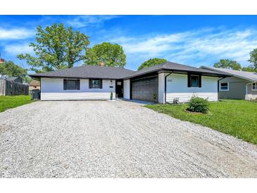 Charming single-story home with a well-maintained lawn and gravel driveway at 3237 Thurston Dr, Indianapolis, IN 46224