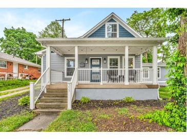 Charming home featuring a covered porch with white columns and an inviting entrance with blue accents at 353 S Indiana St, Danville, IN 46122