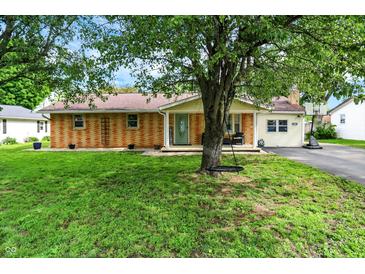 Charming brick home with a well-maintained lawn, a front porch, and mature trees creating curb appeal at 356 Daugherty St, Columbus, IN 47201