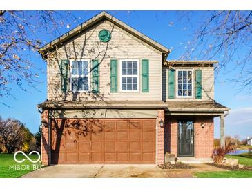 Charming two-story home features a front-facing two-car garage, green shutters, and a well-maintained lawn at 6756 Wimbledon Dr, Zionsville, IN 46077