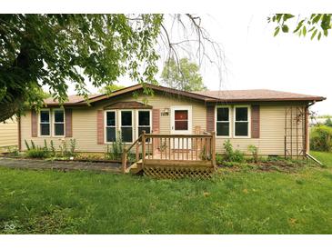 Charming single-story home featuring a front porch and well-maintained lawn and beige vinyl siding at 7214 W Reformatory Rd, Fortville, IN 46040