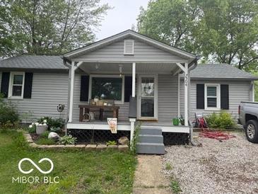 Charming single-story home with gray siding and welcoming front porch at 7504 N Green Meadows, Fairland, IN 46126