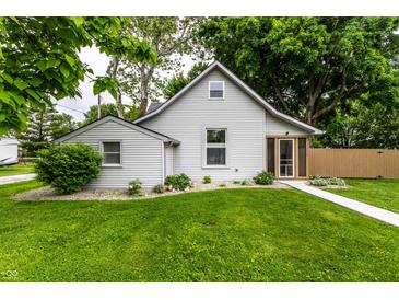 Charming home with gray siding, lush green lawn, and a welcoming walkway leading to a screened-in porch at 7536 Mccord St, McCordsville, IN 46055
