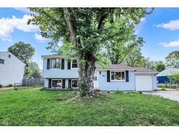 Charming two-story home featuring light blue siding, black shutters, and a well-manicured lawn at 7915 Broadview Dr, Indianapolis, IN 46227