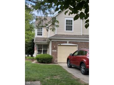 Inviting two-story home with a brick facade, manicured lawn, and an attached single-car garage at 9535 Longwell Dr, Indianapolis, IN 46240