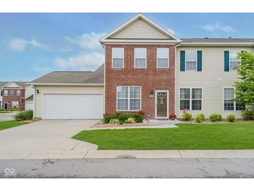 Charming two-story home featuring a brick facade, attached garage, and well-manicured front lawn at 9689 Wild Iris Dr, Noblesville, IN 46060