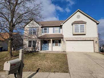Charming two-story home featuring vinyl siding, blue shutters, a driveway, and an attached two-car garage at 11754 Hamble Dr, Indianapolis, IN 46235