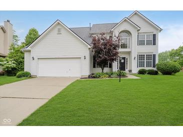 Charming two-story home features an attached two-car garage and a well-manicured lawn at 13896 Fernleaf Way, Carmel, IN 46033