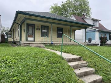 Charming single-story home featuring a welcoming front porch and a well-maintained lawn at 1546 Wade St, Indianapolis, IN 46203