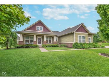 Charming home with a manicured lawn, professional landscaping, and a welcoming front porch at 16071 Prince Ct, Noblesville, IN 46062