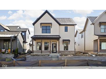 Beautiful two-story home with cream colored siding, dark trim, and brick porch detail at 17339 Newton Main St, Westfield, IN 46074