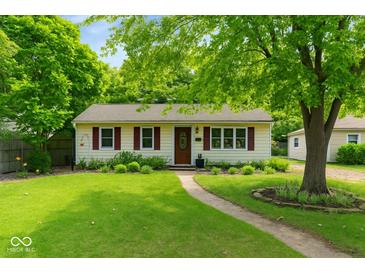 Charming single-story home with a well-manicured lawn, mature trees, and a welcoming walkway at 332 Campus Ln, Indianapolis, IN 46219
