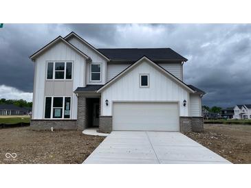 New two-story home featuring a two-car garage, brick accents, and a modern design under a cloudy sky at 6338 Rippling Rock Dr, Plainfield, IN 46168