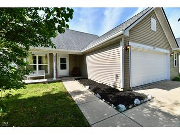Charming single-Gathering home featuring a two-car garage, neutral siding, and a welcoming front walkway with landscape at 8325 Chesterhill Ln, Indianapolis, IN 46239
