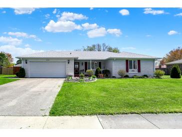 Charming single-story home with white brick, red shutters, and a well-manicured lawn at 1111 Cambridge Dr, Greenwood, IN 46142