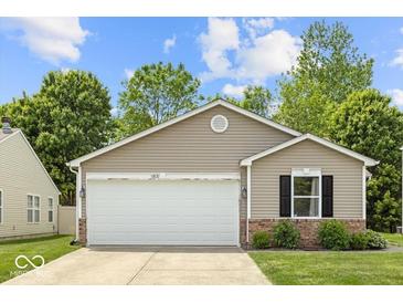Charming single-story home with a two-car garage and well-maintained front yard, nestled in a quiet neighborhood at 11821 Wapiti Way, Noblesville, IN 46060
