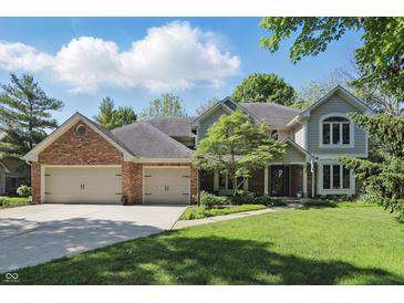 Charming two-story home with a well-manicured lawn, brick accents, and an attached two-car garage at 12335 Old Stone Dr, Indianapolis, IN 46236