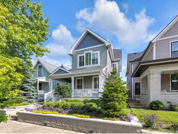 Charming two-story home with manicured front yard landscaping and inviting front porch at 1322 Marlowe Ave, Indianapolis, IN 46202