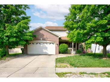 Charming home featuring a brick facade, two-car garage, and well-maintained lawn with mature trees at 286 N Greenbriar Dr, Greenwood, IN 46142