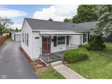 Charming home featuring a well-maintained yard and a welcoming red door at 454 E Broadway St, Greenwood, IN 46143