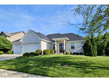 Charming single-story white brick home featuring a well-manicured front lawn at 5347 Sampson Dr, Indianapolis, IN 46237