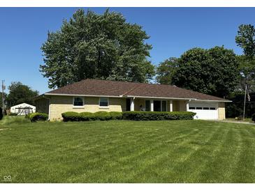 Charming single-story home with a well-manicured lawn, a garage, and lovely curb appeal at 7127 Lincoln St, Anderson, IN 46013