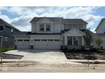 New construction two-story home featuring a spacious three-car garage and modern architectural details at 7145 Firestone Rd, Whitestown, IN 46075