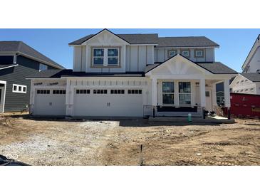 Charming new two-story home featuring a three-car garage and modern architectural details at 7145 Firestone Rd, Whitestown, IN 46075