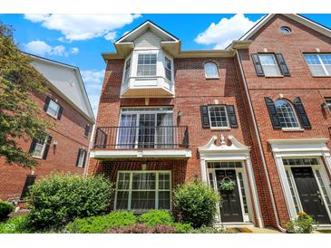 Beautiful brick townhouse with a balcony and well-maintained landscaping at 73 11Th Nw St, Carmel, IN 46032