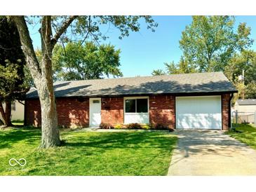 Charming single-story brick home with well-manicured lawn and attached garage at 8744 Montery Ct, Indianapolis, IN 46226