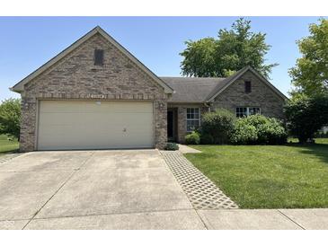 Charming brick home with attached garage and manicured lawn, offering curb appeal and functionality at 11014 Lake Run Dr, Fishers, IN 46038