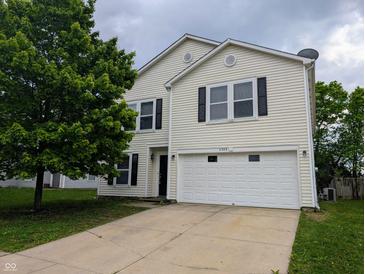 Two-story home with a two-car garage, tree in the yard, and vinyl siding at 11343 Congaree Way, Indianapolis, IN 46235