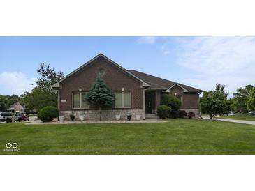 Charming brick home with well-manicured lawn and a tasteful stone accent base at 121 George Ct, Danville, IN 46122