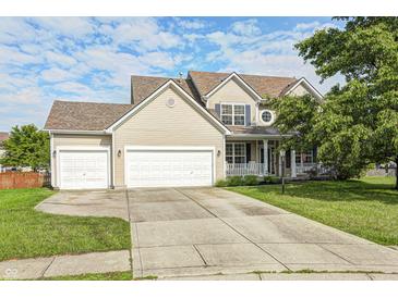 Charming two-story home with a well-maintained lawn and two-car garage under a partly cloudy sky at 1306 Flat Wood Ct, Brownsburg, IN 46112