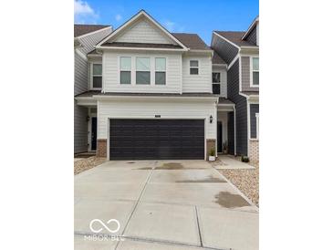 Charming two-story home with a black garage door, paved driveway, and gravel landscaping at 14350 Ludwell Ct, Fishers, IN 46037