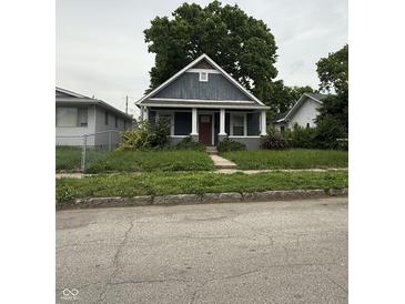 Charming single-Gathering home featuring a quaint porch and a well-maintained front yard at , Indianapolis, IN 46202