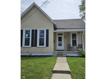 Charming single-story home featuring a cozy front porch and well-maintained landscaping at 179 E Pearl St, Greenwood, IN 46143