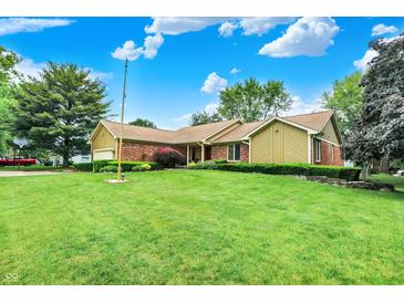 Charming single-story home featuring a well-manicured lawn, beautiful landscaping, and a brick exterior at 201 Angela Ct, Noblesville, IN 46062