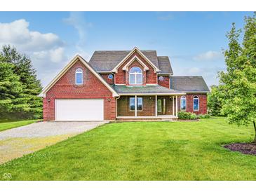 Beautiful two-story brick home featuring a well-manicured lawn and attached garage at 7333 State Road 42, Martinsville, IN 46151