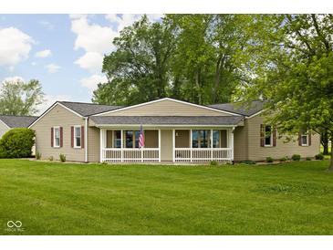Charming ranch-style home with a covered porch and spacious front yard, perfect for outdoor activities at 7990 S County Road 200 E, Pittsboro, IN 46167